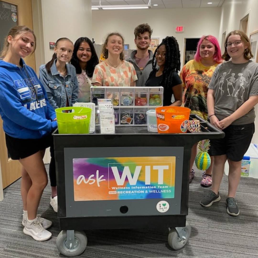 Image of several student peer educators by the Ask WIT mobile cart.